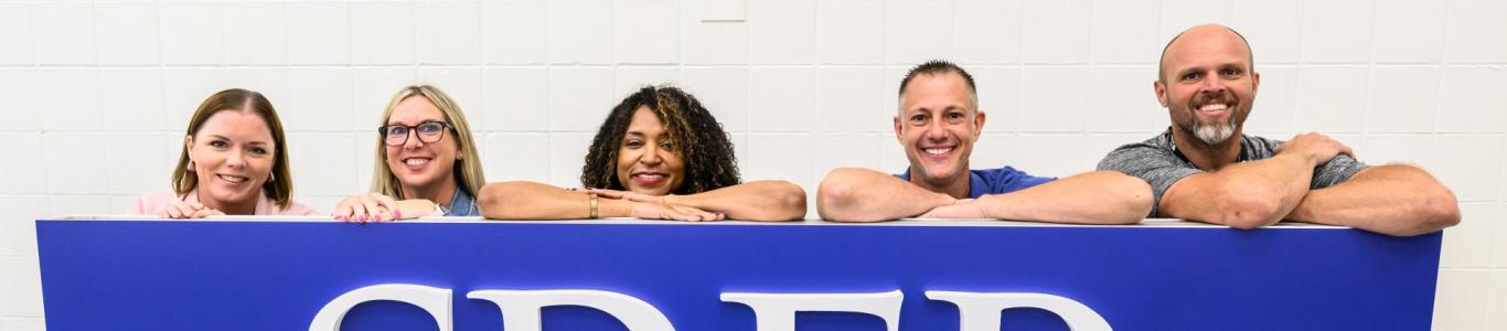 2025 attendees pose at the SREB sign