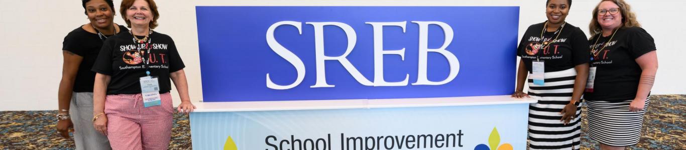 2025 attendees pose in front of an SREB sigh