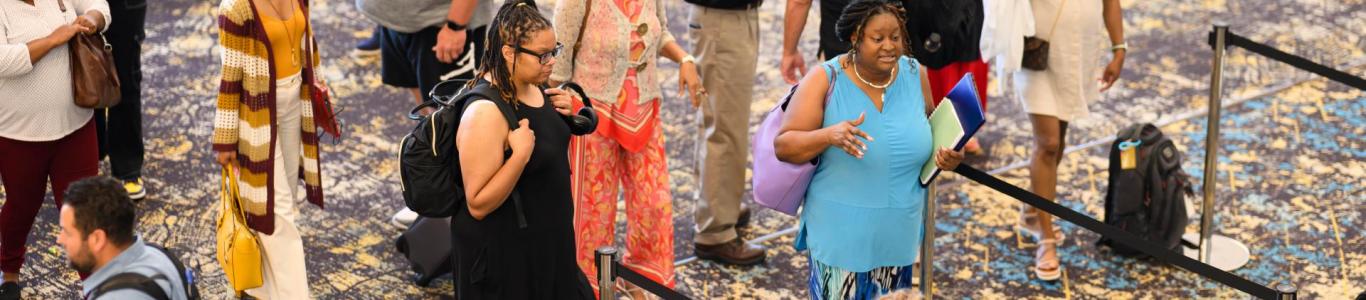 Attendees go to register at the 2025 conference