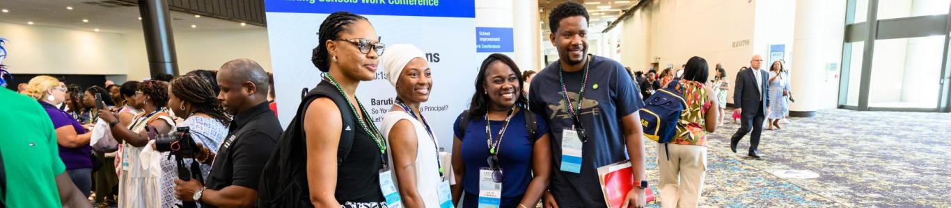 2025 attendees stand in front of an SREB sign