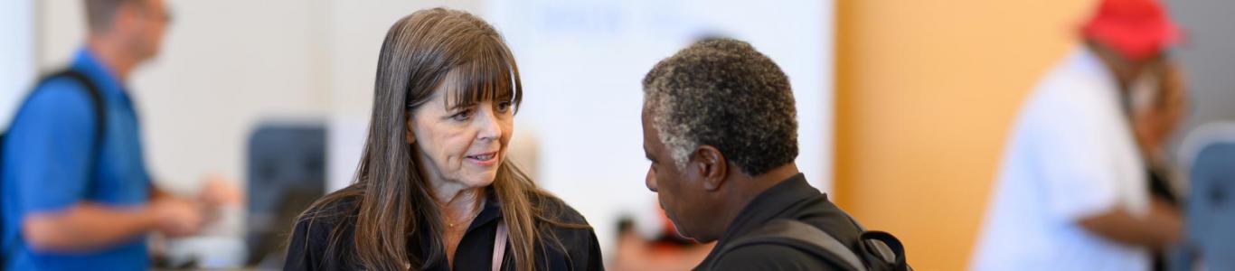 2025 attendee asks an SREB team member for assistance