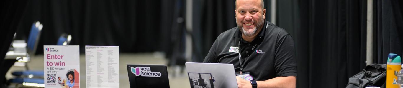 YouScience sets up their exhibitor booth at the 2025 conference