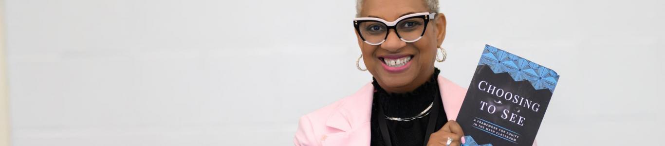 An author sets up her book signing table at the 2025 conference