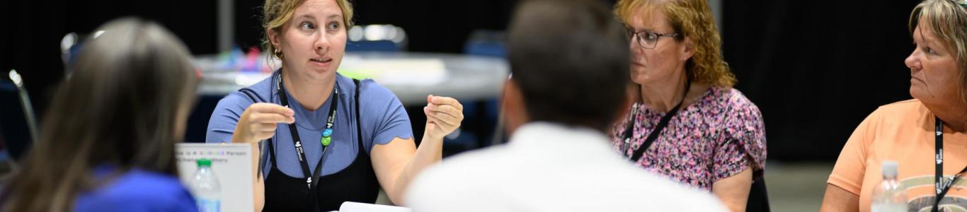 Attendees at the 2025 conference have a discussion during a session