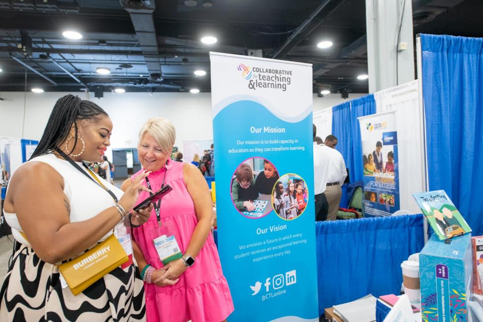 Attendees visiting exhibitor booth