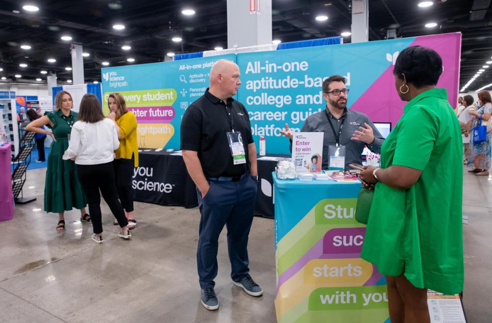 Attendees and sponsors meet in exhibit hall