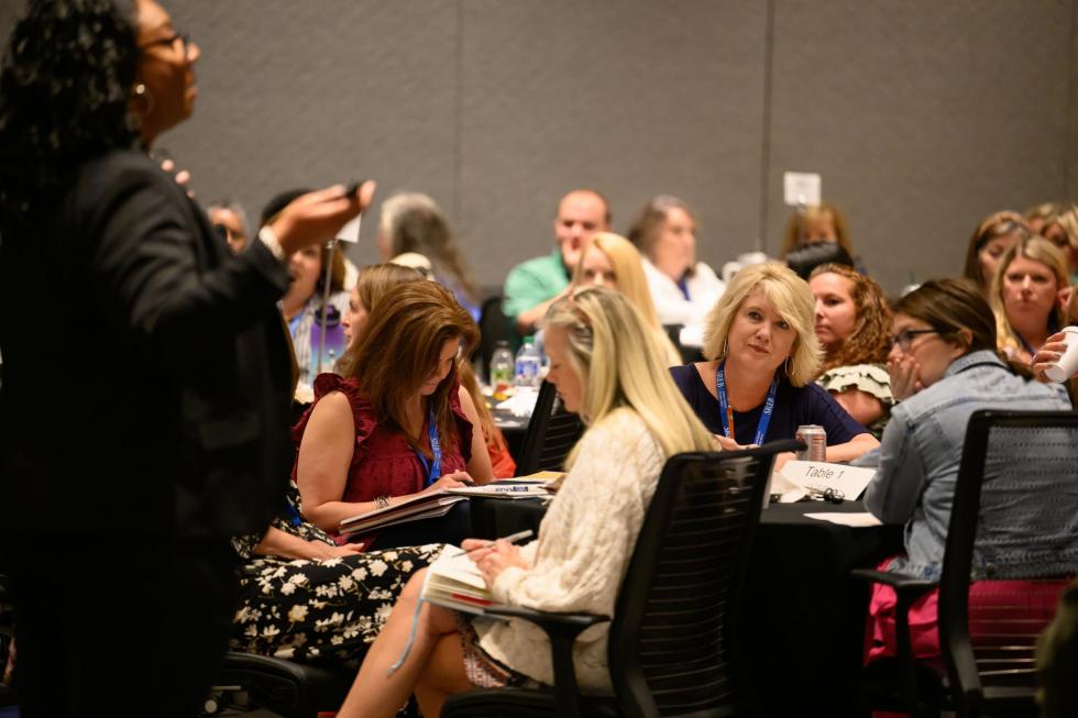 Attendees listening to presenter at past conference